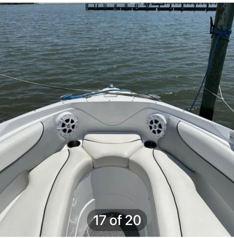 Slide: The Image of 2015 Rinker 246 Captiva Bowrider boat interior with white seating and water view. - 9