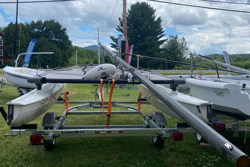Slide: The Image of Hobie 16 catamaran on trailer, grassy area, cloudy sky, 2017 model. - 4