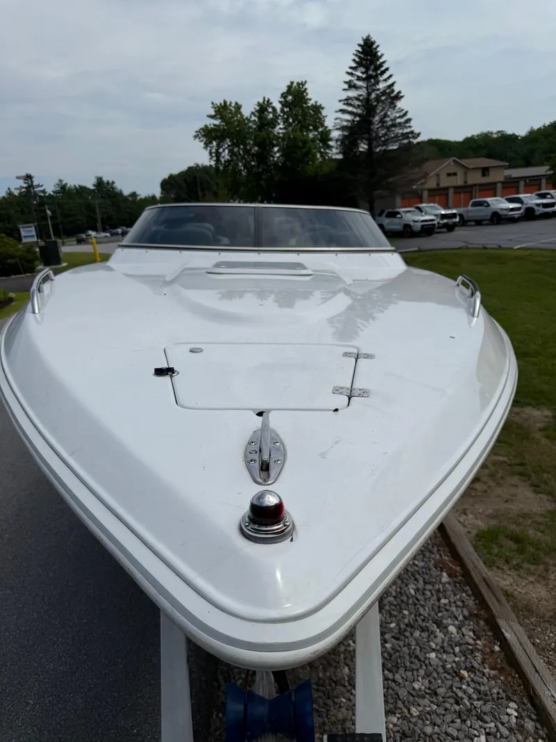 Slide: The Image of 1999 Donzi 26 ZX boat on trailer, front view, parked outdoors. - 10