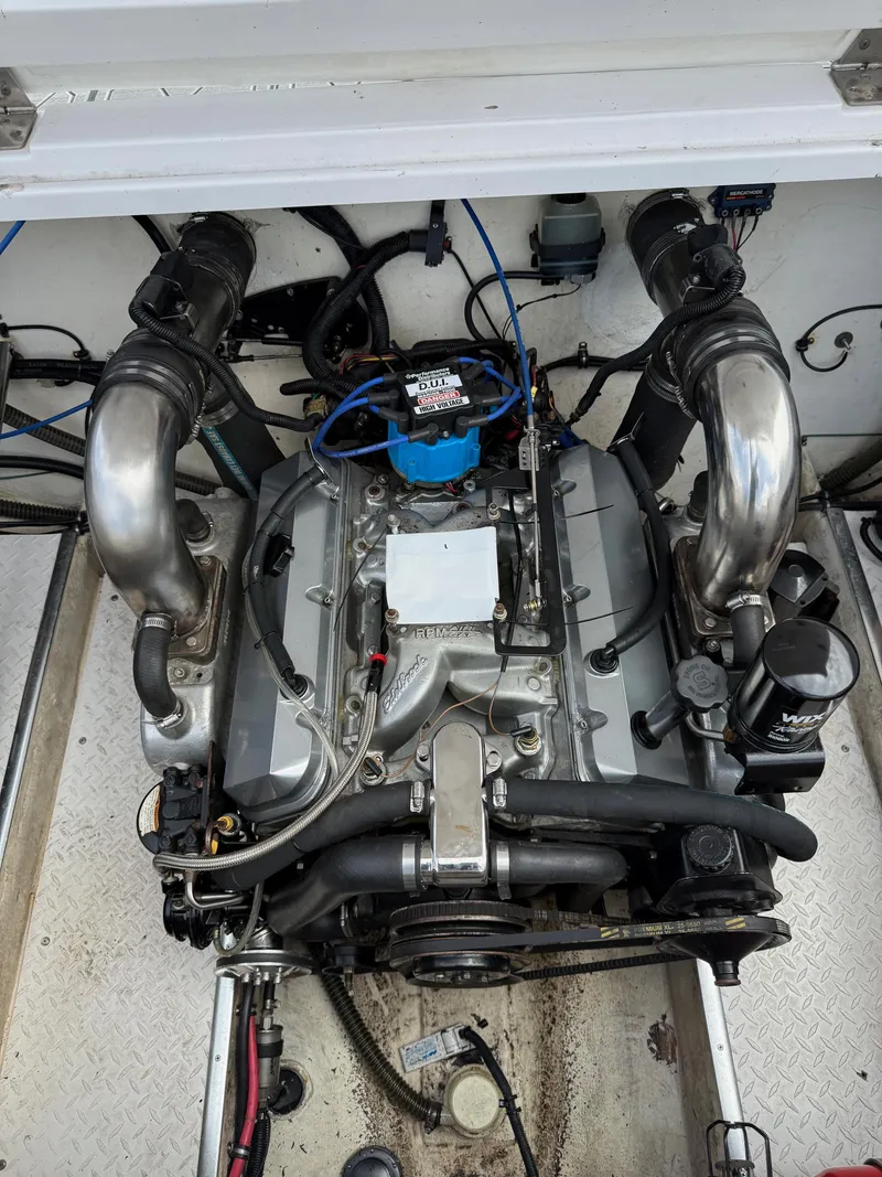 Slide: The Image of 1999 Donzi 26 ZX engine compartment with visible components and wiring. - 13