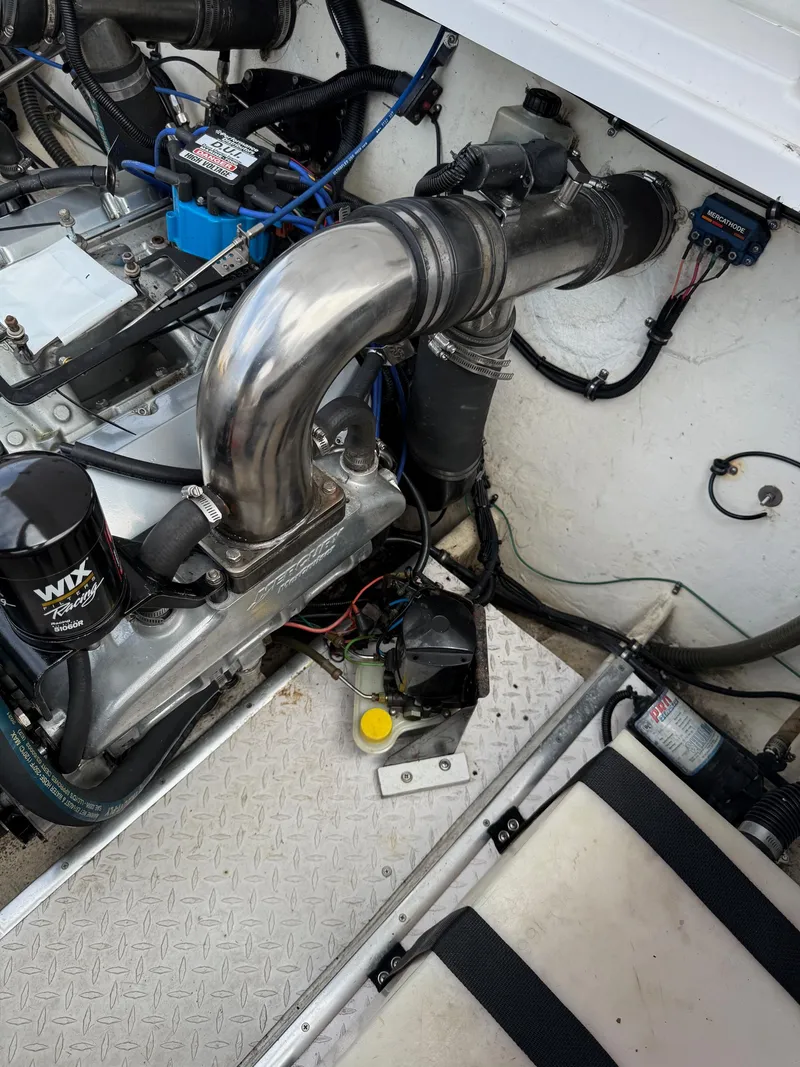 Slide: The Image of Engine compartment of a 1999 Donzi 26 ZX boat, featuring detailed mechanical components. - 14