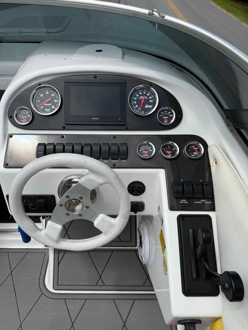 Slide: The Image of 1999 Donzi 26 ZX boat dashboard with steering wheel and gauges. - 15