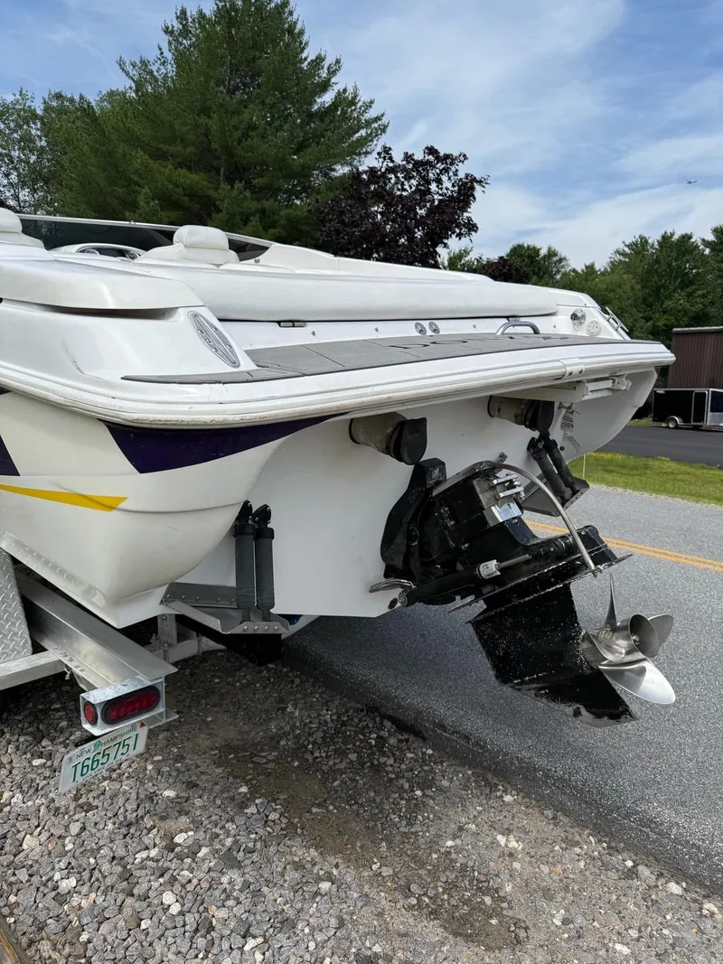 Slide: The Image of 1999 Donzi 26 ZX boat on trailer, rear view with outboard motor, parked on roadside. - 6