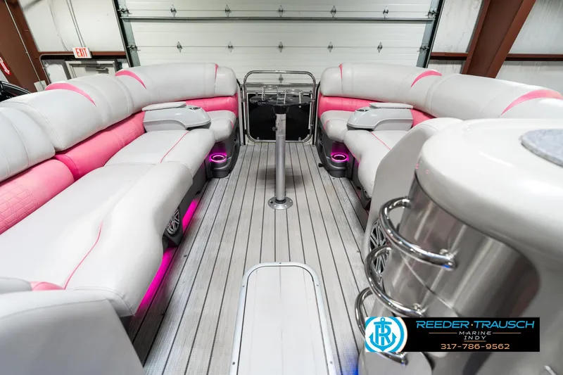 Slide: The Image of Luxurious 2019 Avalon Ambassador 27' pontoon boat interior with pink accents and modern seating. - 21