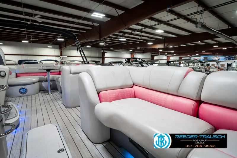 Slide: The Image of Luxurious 2019 Avalon Ambassador 27' pontoon boat interior with plush seating in a showroom. - 25