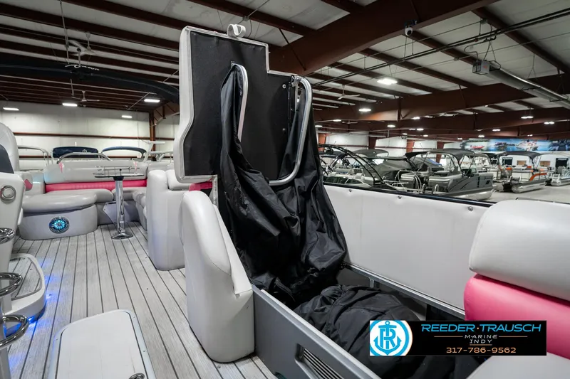 Slide: The Image of 2019 Avalon Ambassador 27' boat interior with seating and storage, displayed in a showroom. - 26