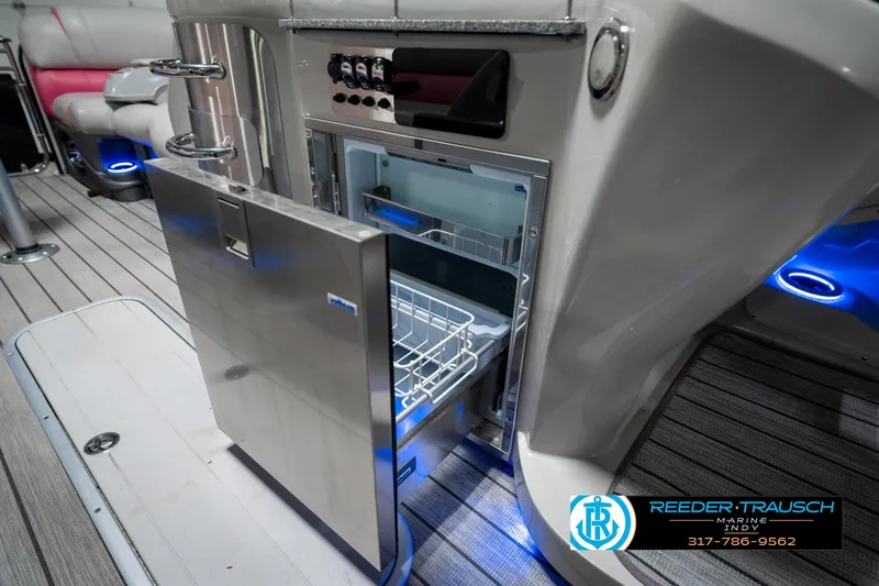 Slide: The Image of Open stainless steel refrigerator on 2019 Avalon Ambassador 27' boat with modern interior design. - 29