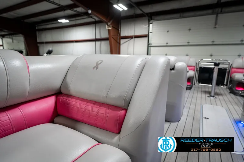 Slide: The Image of Luxurious seating in 2019 Avalon Ambassador 27' boat, featuring pink accents and ribbon detail. - 30