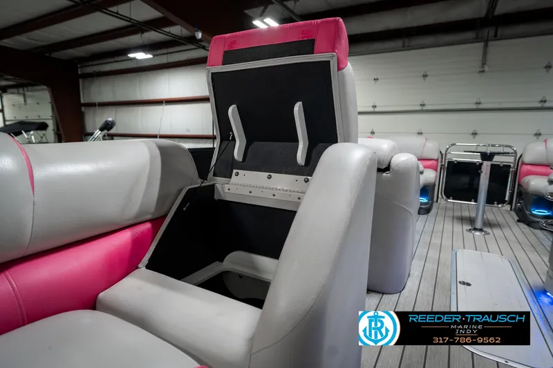 Slide: The Image of 2019 Avalon Ambassador 27' boat interior with pink and gray seating, storage compartment open. - 31