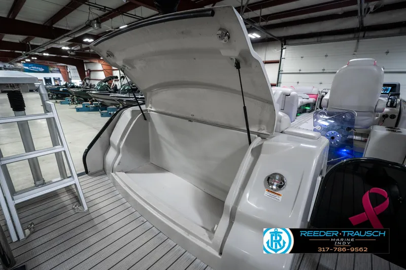 Slide: The Image of 2019 Avalon Ambassador 27' boat interior with open storage compartment in showroom. - 38