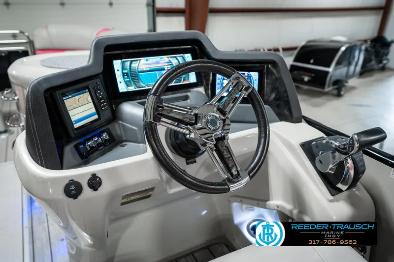 Slide: The Image of 2019 Avalon Ambassador boat dashboard with steering wheel and digital displays in a showroom. - 40