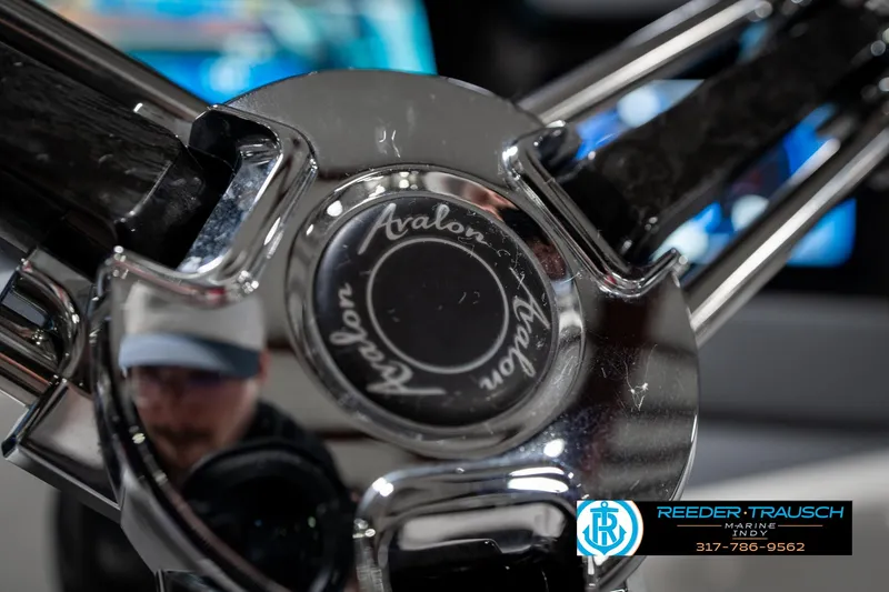 Slide: The Image of Close-up of Avalon Ambassador 27' steering wheel, 2019 model, with Reeder-Trausch Marine logo. - 41