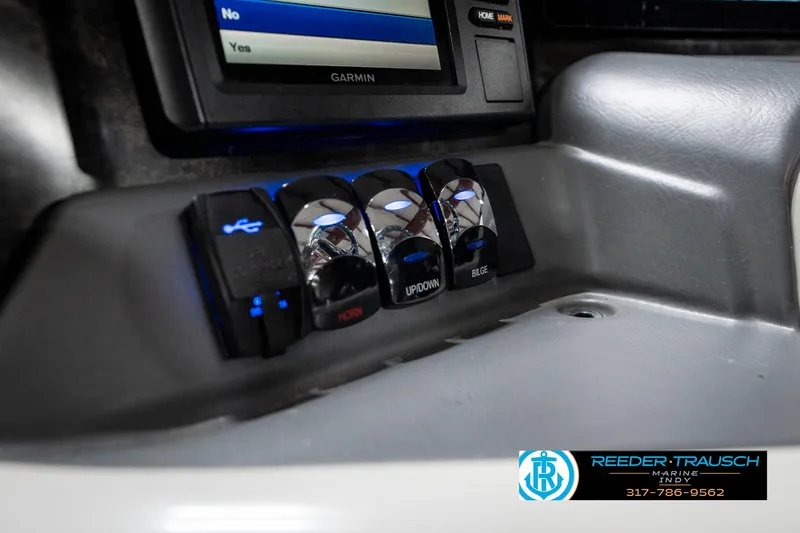 Slide: The Image of Control panel of 2019 Avalon Ambassador boat with switches and Garmin display. - 46