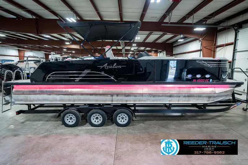 Slide: The Image of 2019 Avalon Ambassador 27' pontoon boat on trailer in indoor showroom. - 7