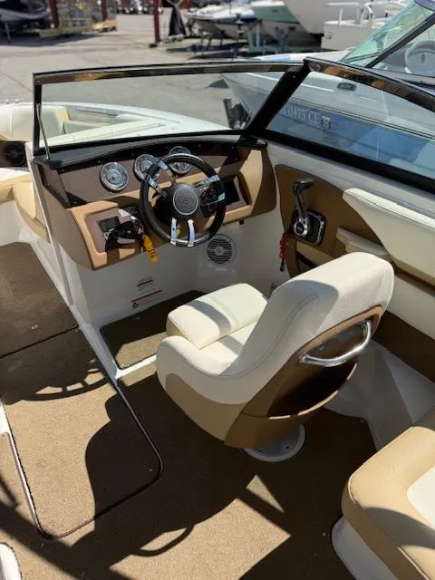 Slide: The Image of 2020 Cobalt CS23 boat interior with steering wheel and beige seating. - 11