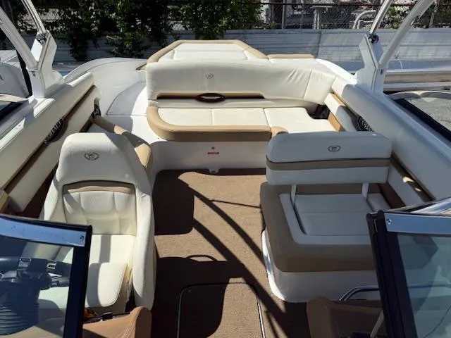 Slide: The Image of 2020 Cobalt CS23 boat interior with beige seating and carpeted floor. - 14
