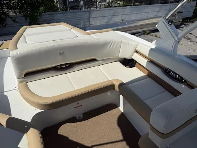 Slide: The Image of Interior of a 2020 Cobalt CS23 boat with beige and white seating. - 15