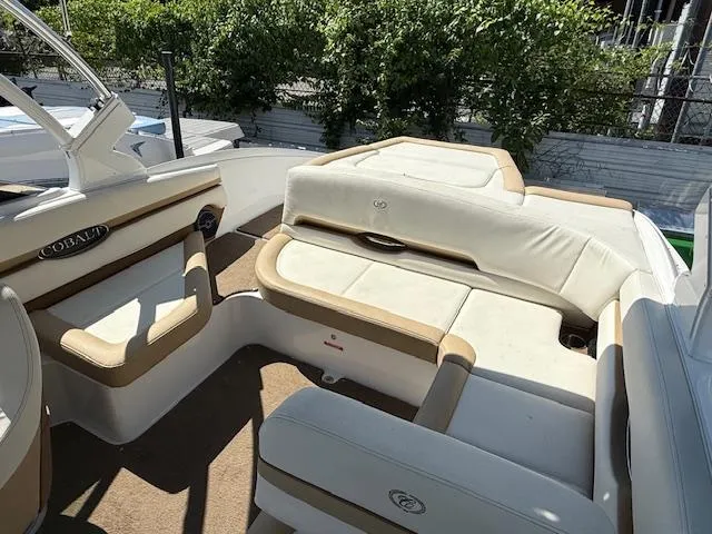 Slide: The Image of 2020 Cobalt CS23 boat interior with beige seating and brown accents. - 18