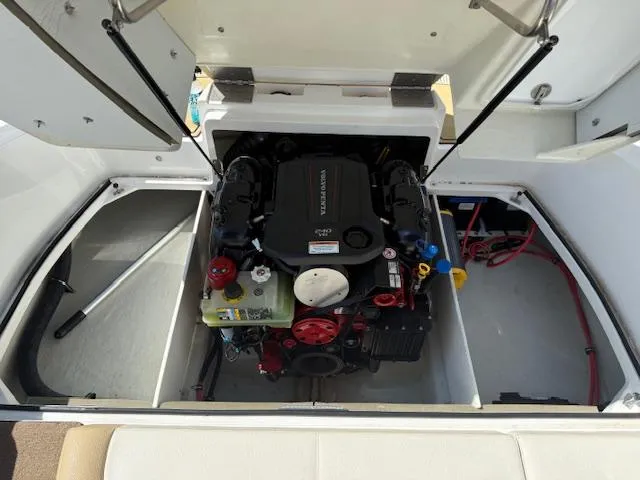 Slide: The Image of 2020 Cobalt CS23 boat engine compartment with open hatch, showcasing engine components. - 20