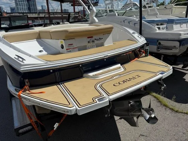 Slide: The Image of 2020 Cobalt CS23 boat with tan deck, docked at marina. - 27
