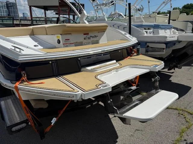 Slide: The Image of 2020 Cobalt CS23 boat with swim platform, parked outdoors on a sunny day. - 28