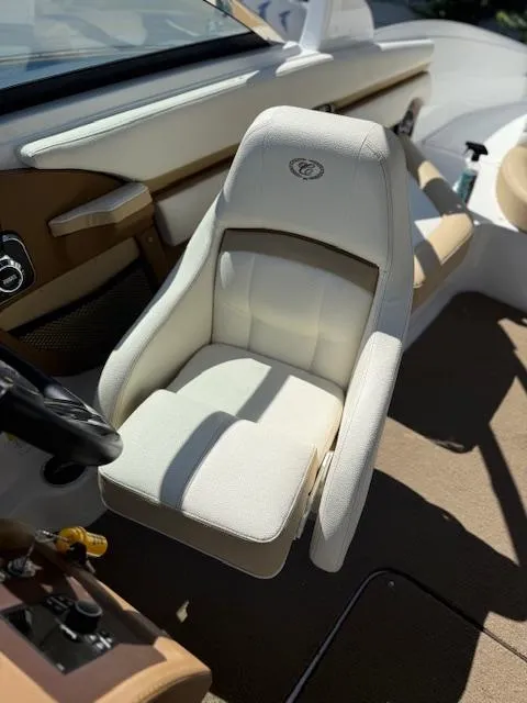 Slide: The Image of Captain's seat in a 2020 Cobalt CS23 boat, featuring beige upholstery and sleek design. - 9
