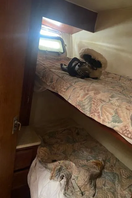 Slide: The Image of 1984 Post 43 Sport Fisherman cabin with bunk beds and nautical decor. - 11