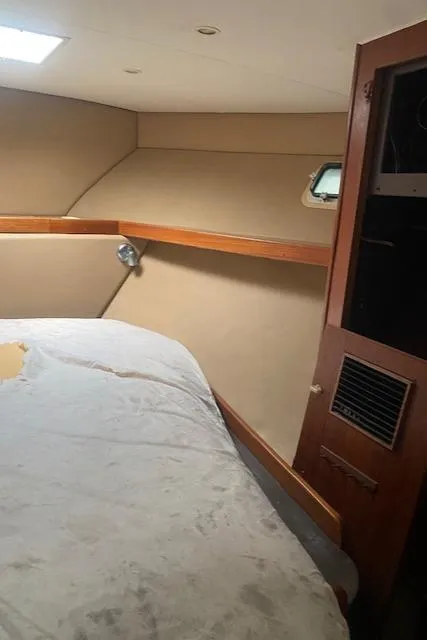 Slide: The Image of Interior cabin of 1984 Post 43 Sport Fisherman boat with bed and wooden accents. - 14