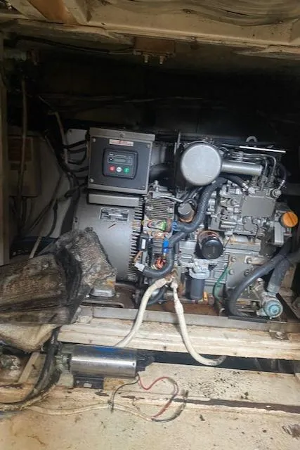 Slide: The Image of Engine room of 1984 Post 43 Sport Fisherman boat, showcasing mechanical components. - 16