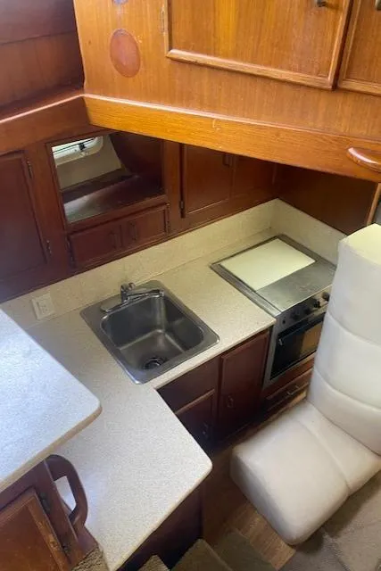 Slide: The Image of 1984 Post 43 Sport Fisherman kitchen with sink, stove, and wooden cabinets. - 10
