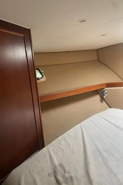 Slide: The Image of 1984 Post 43 Sport Fisherman cabin interior with wood paneling and bed. - 15