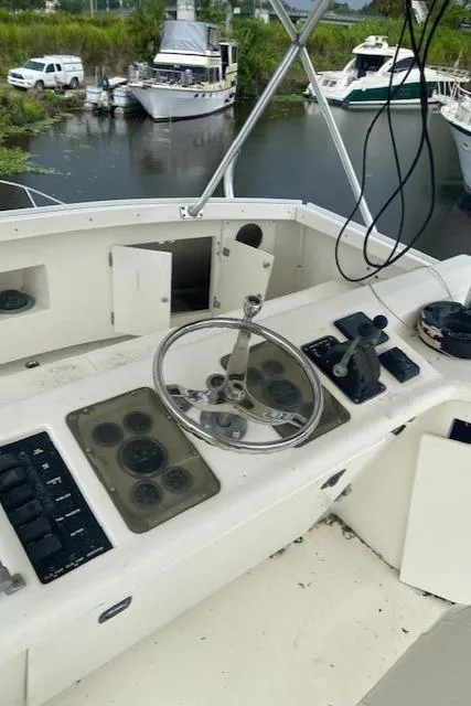 Slide: The Image of 1984 Post 43 Sport Fisherman boat helm with steering wheel and control panel. - 18