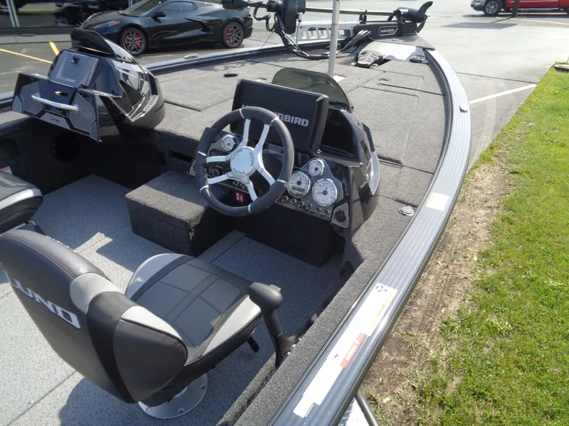 Slide: The Image of 2025 Lund 1875 Pro-V Bass XS boat interior with steering wheel and seating. - 12