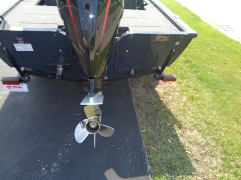 Slide: The Image of Rear view of 2025 Lund 1875 Pro-V Bass XS boat with propeller on pavement. - 8