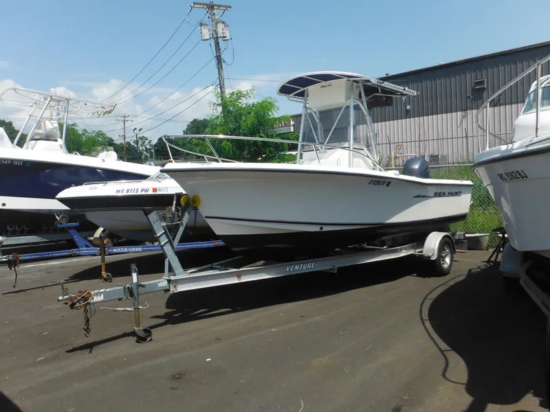 Slide: The Image of 2004 Sea Hunt 202 TRITON boat on trailer, parked outdoors. - 1