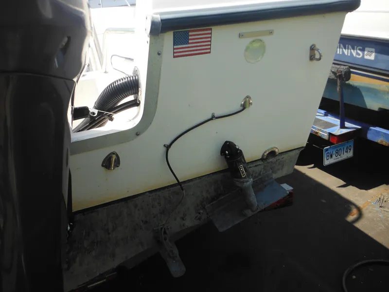 Slide: The Image of 2004 Sea Hunt 202 TRITON boat stern with American flag and trailer. - 10