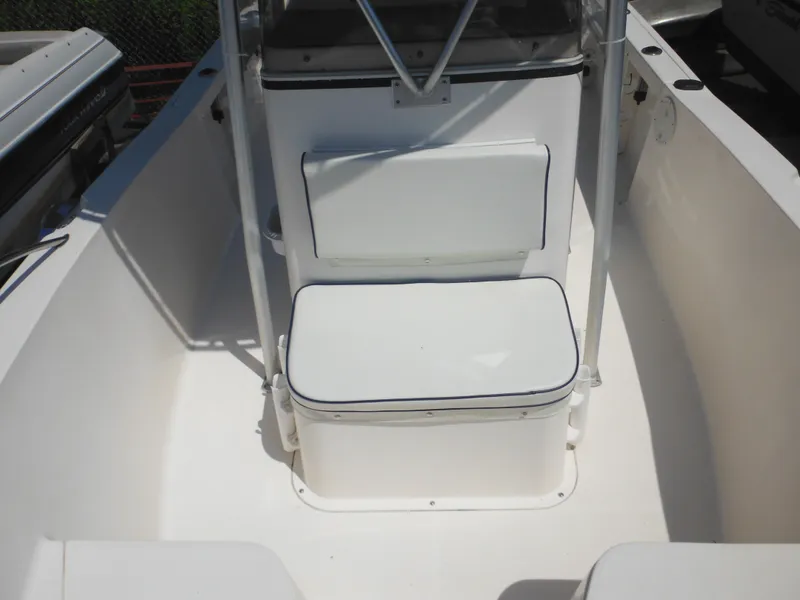 Slide: The Image of 2004 Sea Hunt 202 TRITON boat interior with white cushioned seating. - 17