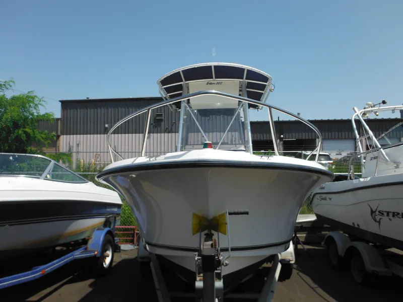 Slide: The Image of 2004 Sea Hunt 202 TRITON boat on trailer, parked outdoors. - 2