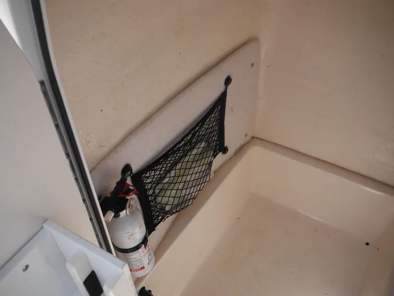 Slide: The Image of Interior of 2004 Sea Hunt 202 TRITON boat with fire extinguisher and netted storage. - 24