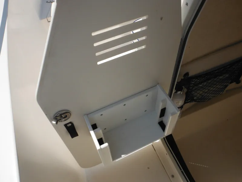 Slide: The Image of 2004 Sea Hunt 202 TRITON boat compartment with storage and ventilation slots. - 25