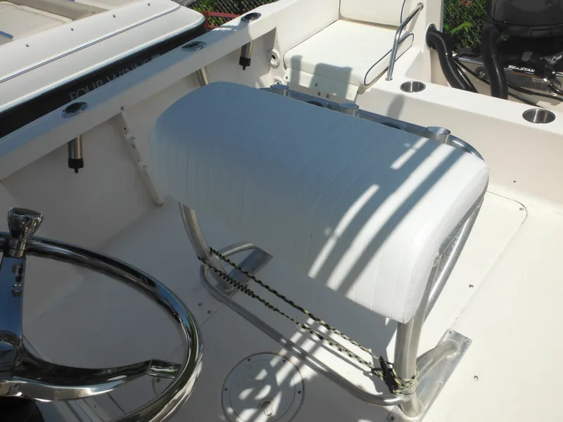 Slide: The Image of 2004 Sea Hunt 202 TRITON boat interior with white seating and steering wheel. - 26