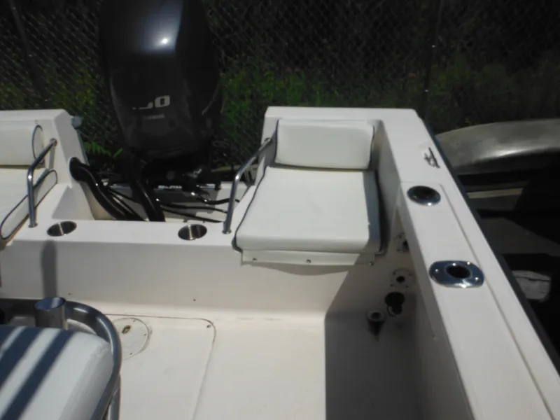Slide: The Image of 2004 Sea Hunt 202 TRITON boat interior with seating and motor. - 27