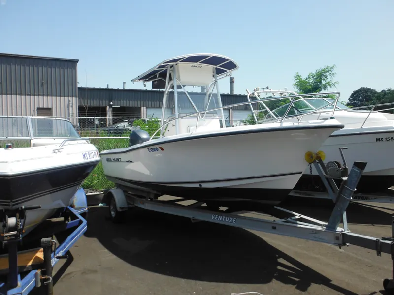 Slide: The Image of 2004 Sea Hunt 202 TRITON boat on trailer, parked outdoors. - 3