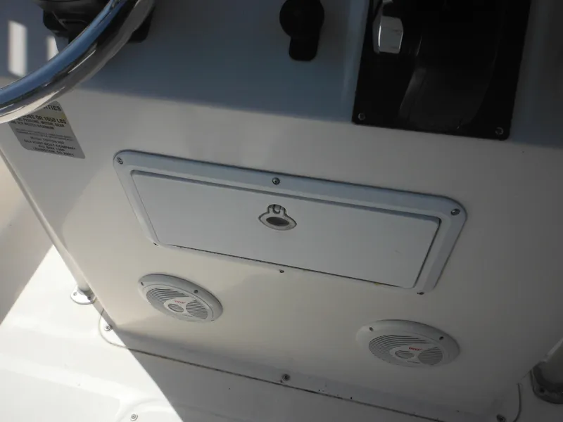 Slide: The Image of Console of 2004 Sea Hunt 202 TRITON boat with storage compartment and speakers. - 44
