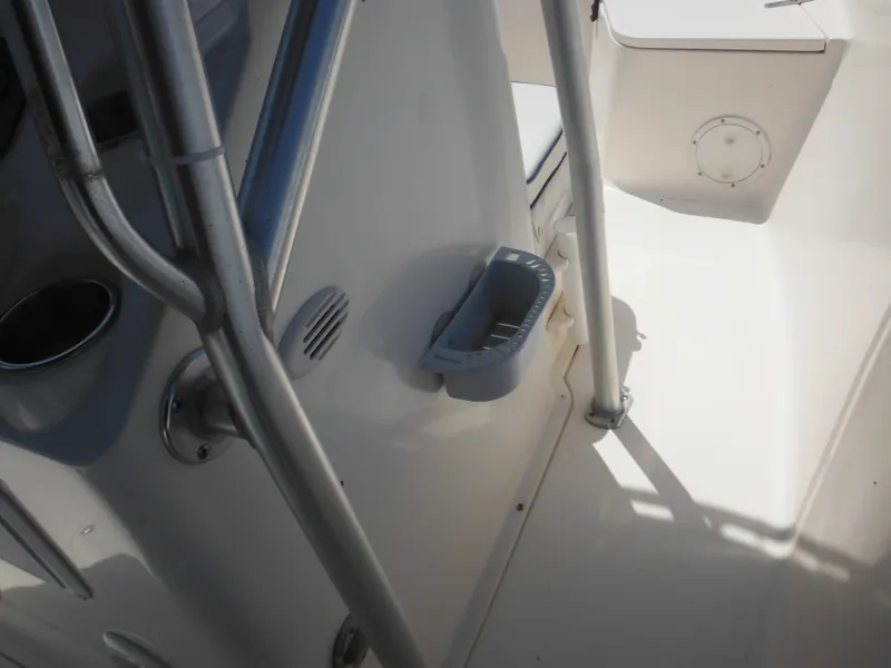 Slide: The Image of 2004 Sea Hunt 202 TRITON boat interior with metal railings and storage compartment. - 46