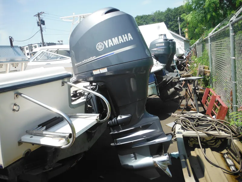 Slide: The Image of 2004 Sea Hunt 202 TRITON with Yamaha outboard motor in a boatyard. - 8
