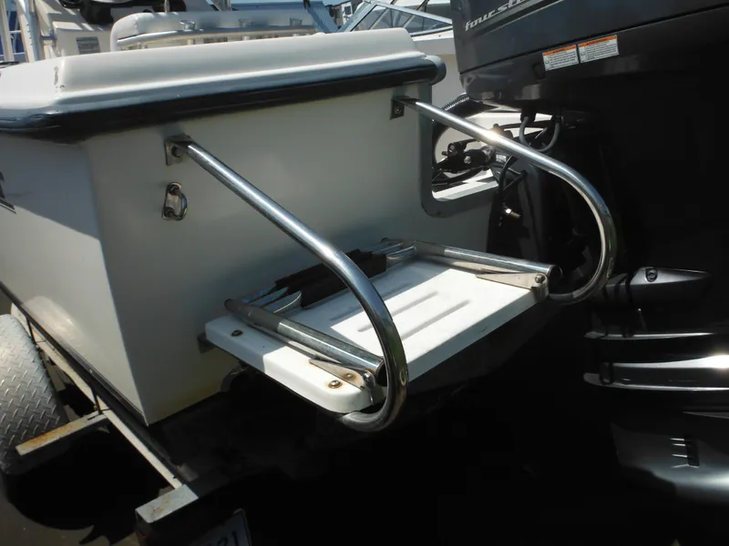 Slide: The Image of 2004 Sea Hunt 202 TRITON boat with stainless steel swim ladder and outboard motor. - 9