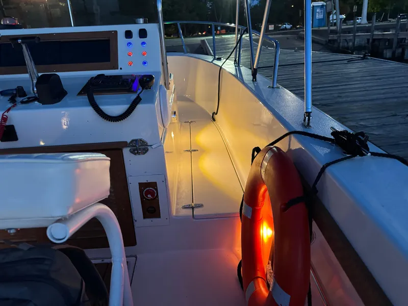 Slide: The Image of Interior of 1987 Custom Biddison 2200 boat with illuminated dashboard and life preserver. - 11