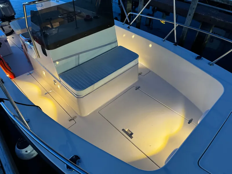 Slide: The Image of 1987 Custom Biddison 2200 boat interior with illuminated seating and deck at dusk. - 14