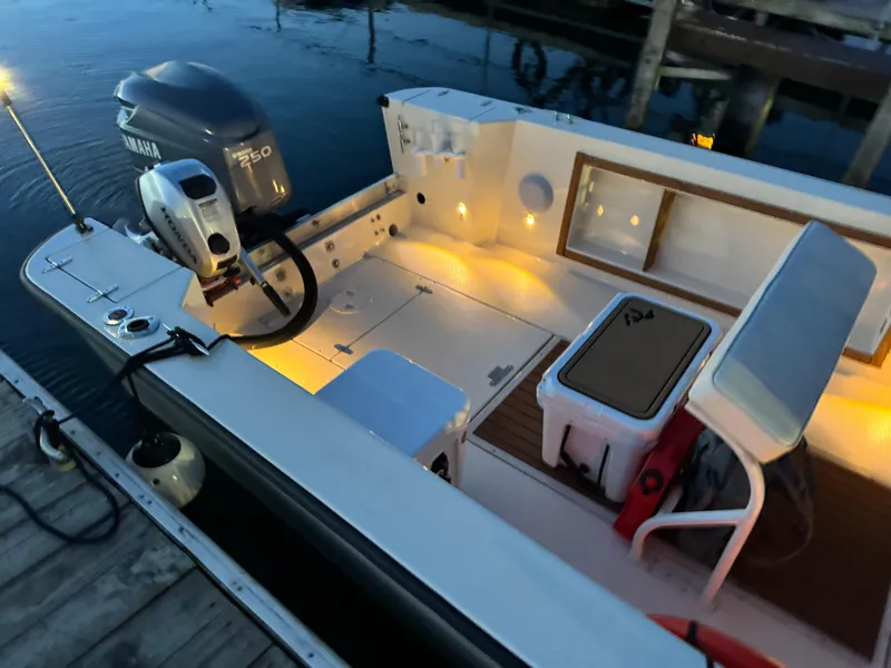 Slide: The Image of 1987 Custom Biddison 2200 boat with Yamaha engine, docked at sunset, interior lights on. - 15